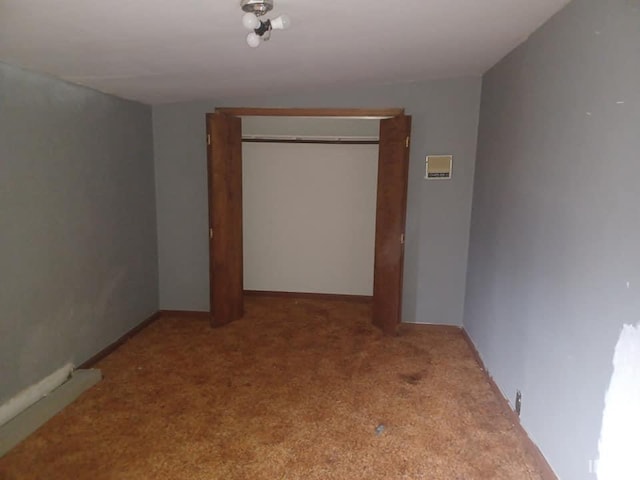 unfurnished bedroom with light carpet and a closet