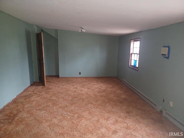 unfurnished room with baseboard heating and light carpet