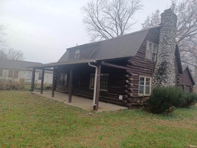 back of property with a porch, a patio, and a lawn