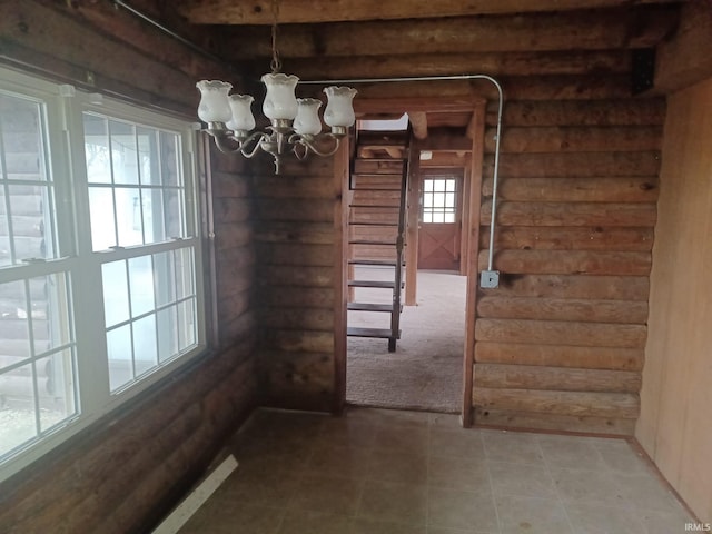 unfurnished dining area featuring a chandelier and carpet floors