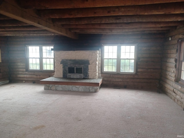 unfurnished living room with log walls, carpet floors, and a healthy amount of sunlight