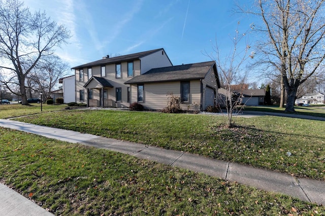 view of front of property featuring a garage and a front yard