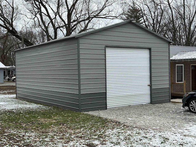 snow covered structure featuring a garage