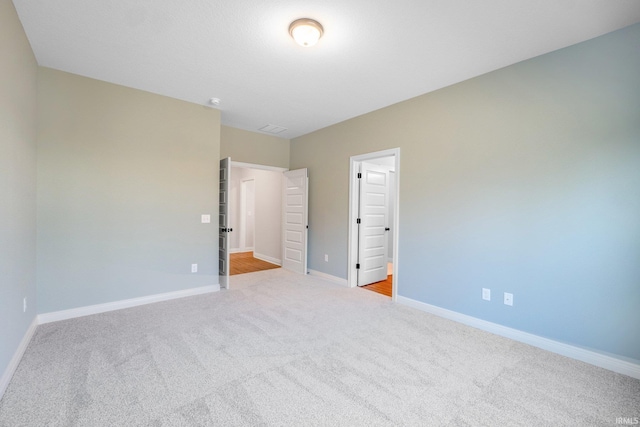 unfurnished bedroom featuring light colored carpet