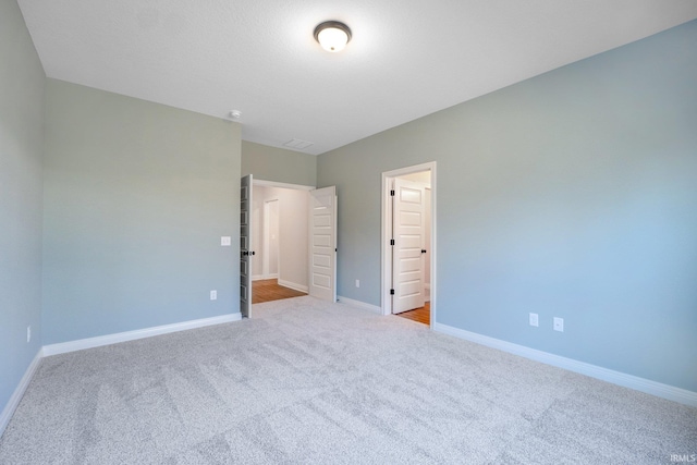 unfurnished bedroom with light colored carpet