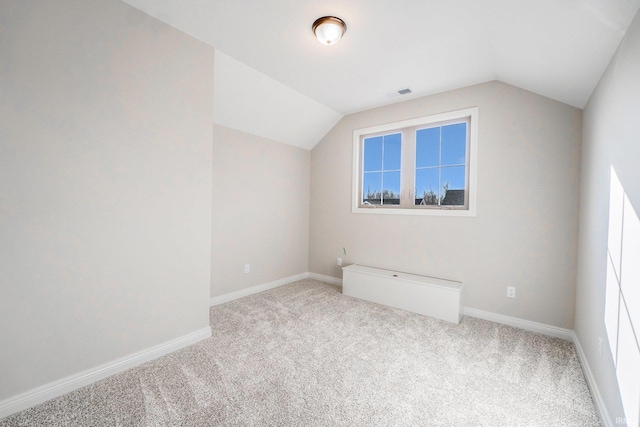 bonus room with light carpet and lofted ceiling