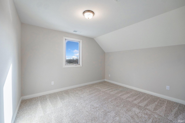 bonus room with carpet and vaulted ceiling