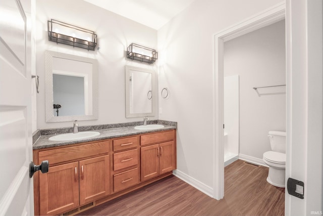 bathroom featuring hardwood / wood-style floors, vanity, and toilet