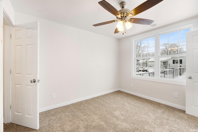 carpeted empty room featuring ceiling fan