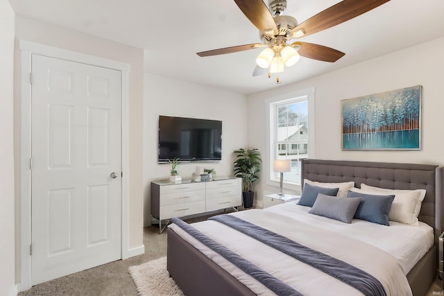 bedroom featuring ceiling fan and carpet