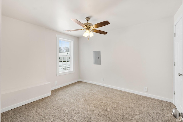 carpeted spare room featuring ceiling fan and electric panel