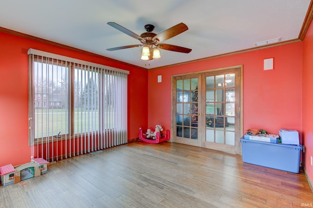 misc room with ceiling fan, light hardwood / wood-style floors, ornamental molding, and french doors