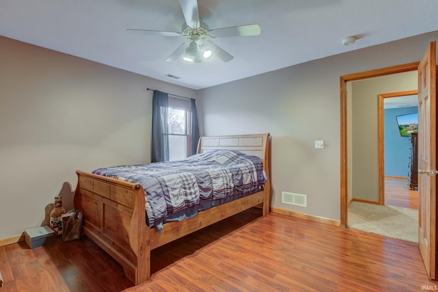 bedroom with hardwood / wood-style flooring and ceiling fan