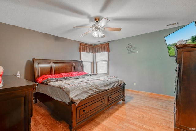 bedroom featuring light hardwood / wood-style flooring and ceiling fan