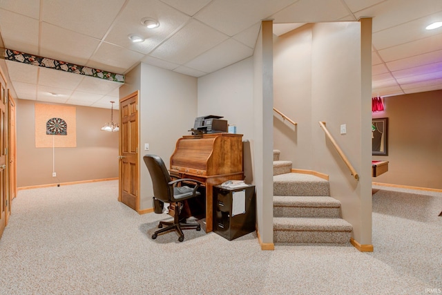 carpeted office with a paneled ceiling