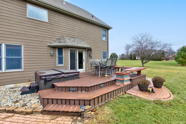 wooden terrace with a lawn and a hot tub