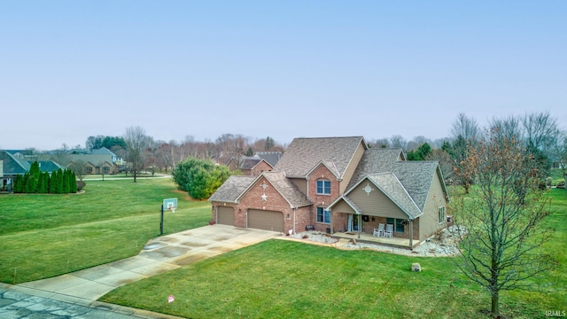 view of front of house featuring a porch, a garage, and a front yard