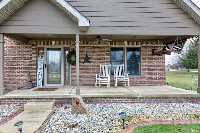 entrance to property with ceiling fan and a porch