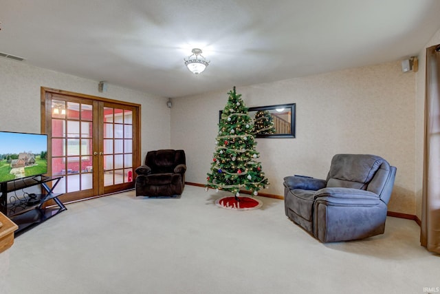 sitting room with carpet flooring and french doors