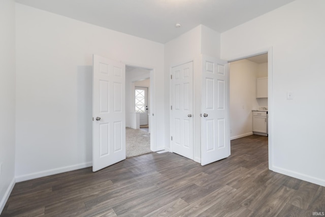 unfurnished bedroom featuring dark hardwood / wood-style flooring