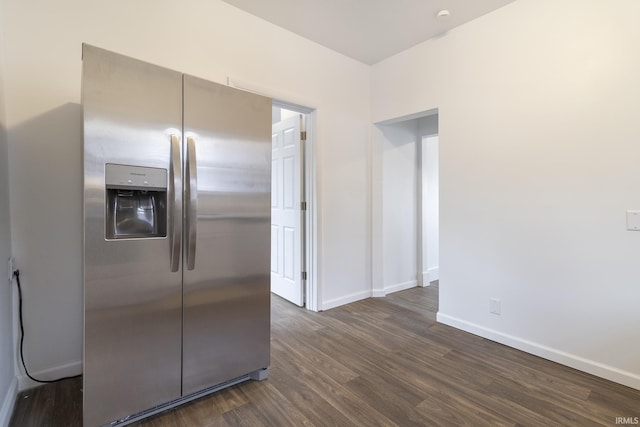 kitchen with stainless steel fridge and dark hardwood / wood-style floors