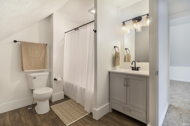 bathroom featuring vanity, a textured ceiling, wood-type flooring, toilet, and lofted ceiling