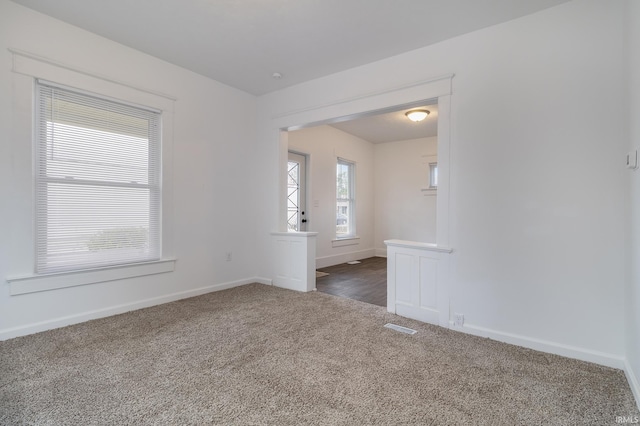 empty room featuring dark colored carpet