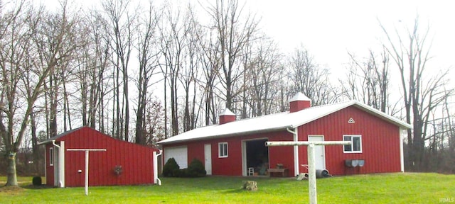 view of outbuilding with a garage and a lawn