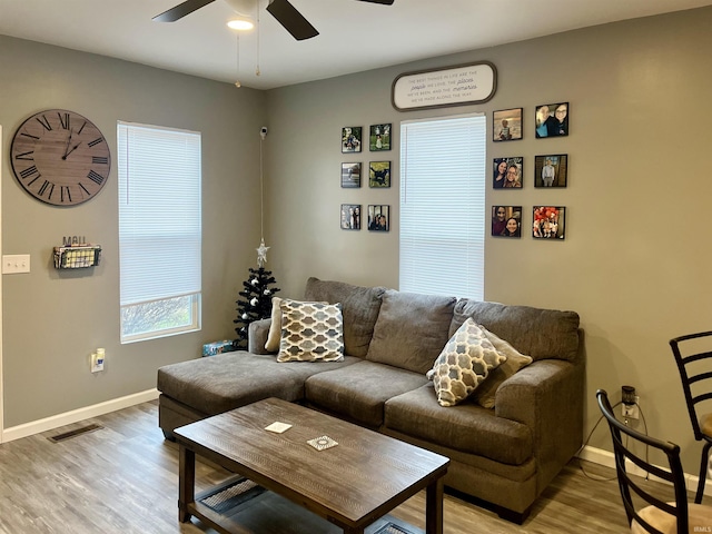 living room with ceiling fan and light hardwood / wood-style floors