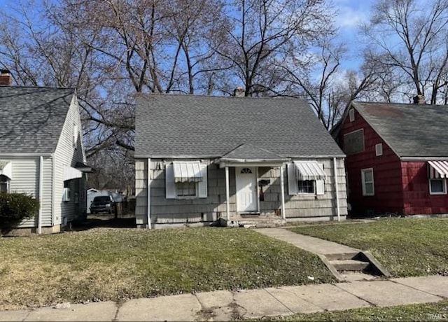 bungalow-style home featuring a front yard