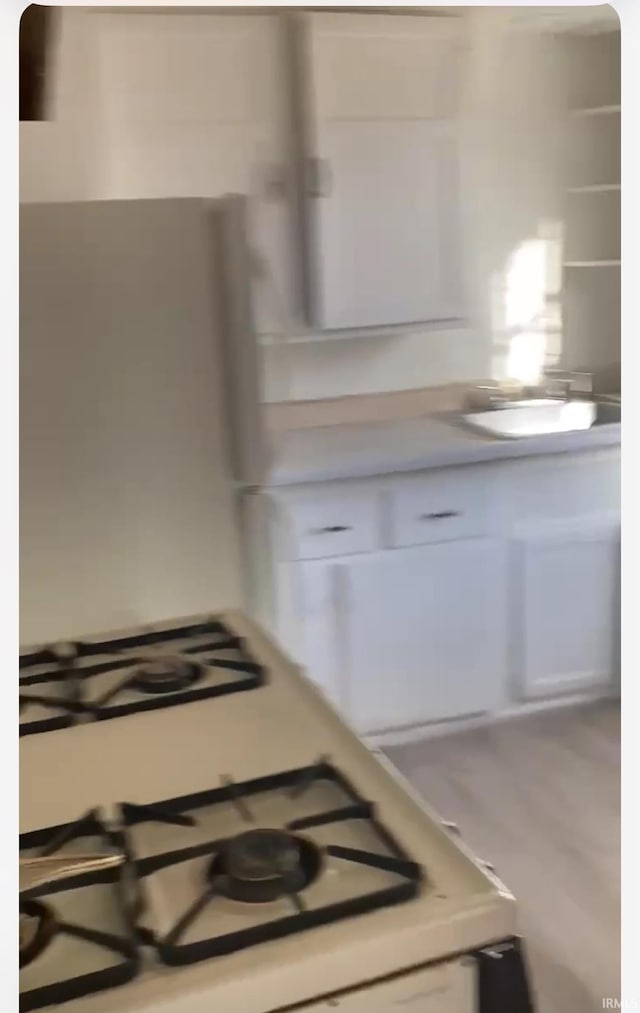 kitchen with white cabinets and cooktop