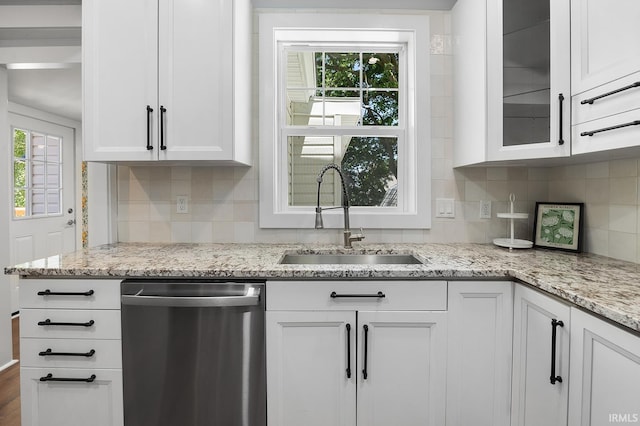 kitchen with white cabinets, dishwasher, and sink