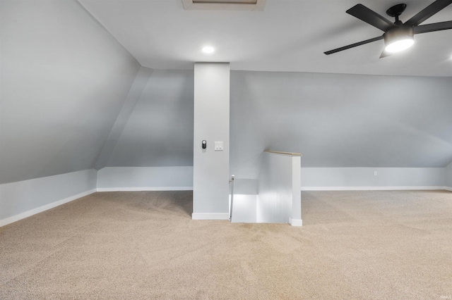 carpeted spare room featuring ceiling fan and lofted ceiling