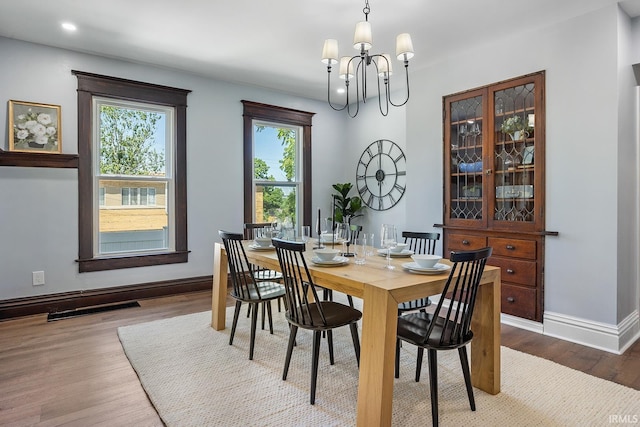 dining area with a chandelier and hardwood / wood-style flooring