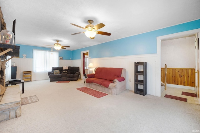 living room with ceiling fan and carpet