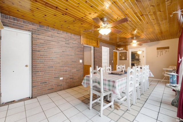 unfurnished dining area featuring ceiling fan and brick wall