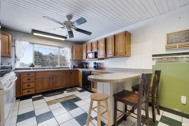 kitchen featuring dishwasher, a kitchen breakfast bar, white range, backsplash, and kitchen peninsula