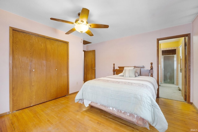 bedroom with a closet, hardwood / wood-style flooring, and ceiling fan