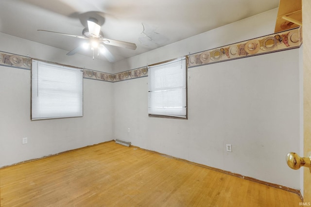 spare room with ceiling fan and hardwood / wood-style flooring