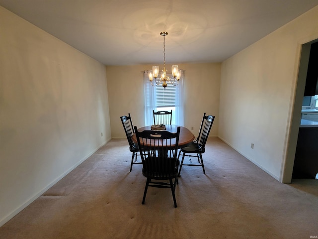 dining space with light colored carpet and an inviting chandelier