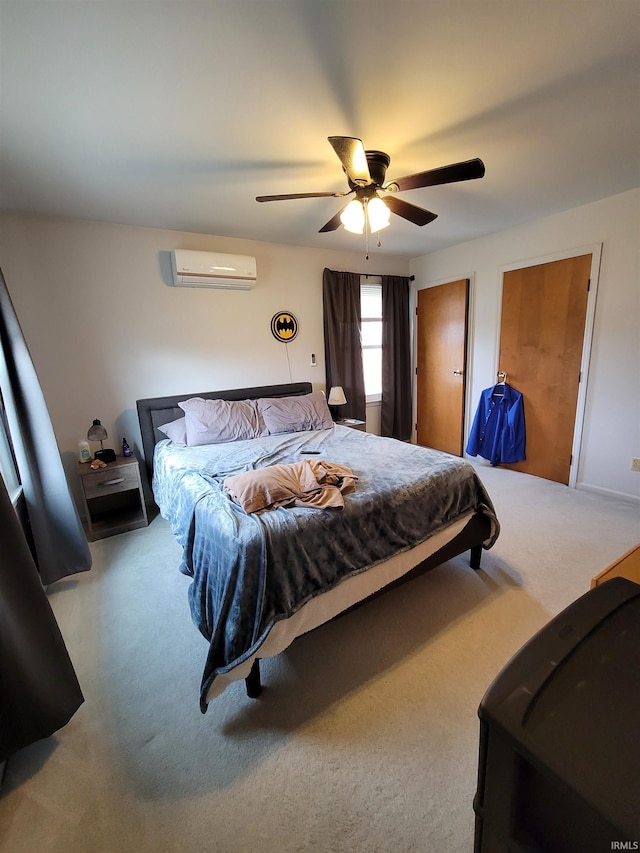 carpeted bedroom featuring a wall unit AC and ceiling fan