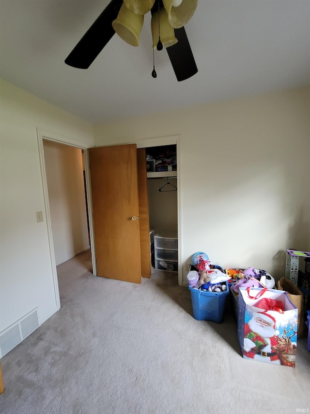 bedroom featuring carpet, ceiling fan, and a closet