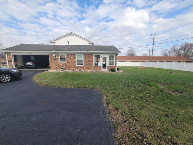 view of front of house with a garage and a front lawn