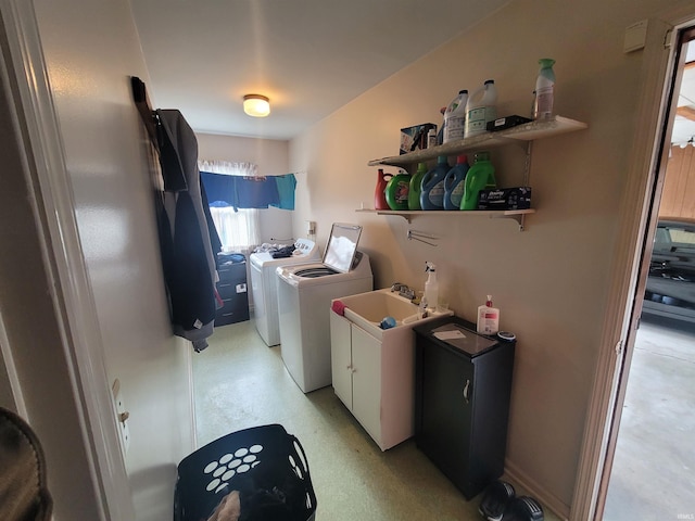 clothes washing area featuring cabinets and washing machine and dryer