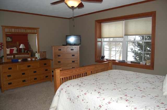 carpeted bedroom with ceiling fan and crown molding