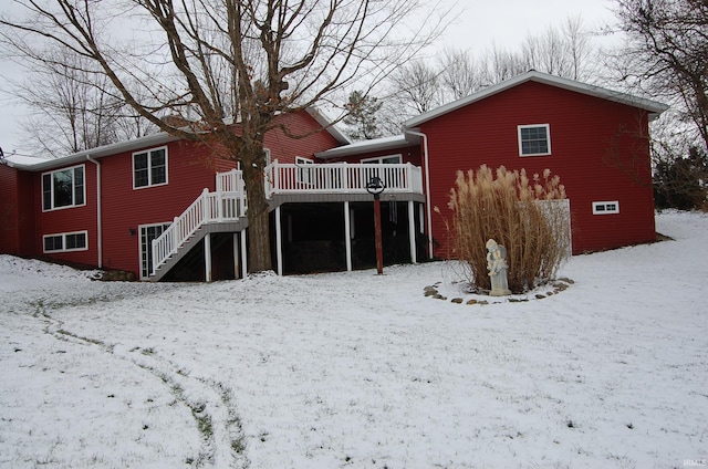 snow covered house with a deck