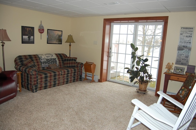 carpeted living room with a baseboard radiator