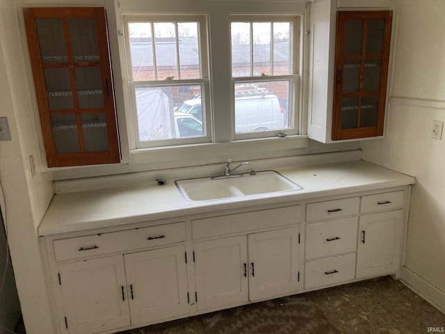 kitchen with white cabinetry and sink