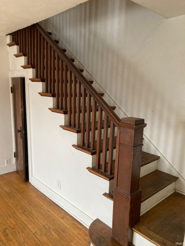 stairs featuring hardwood / wood-style flooring