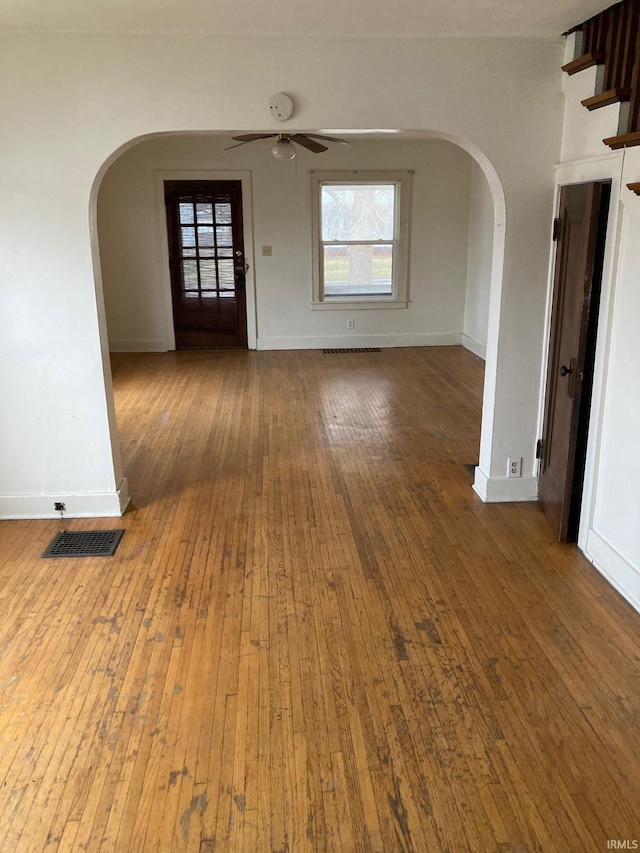 empty room with ceiling fan and hardwood / wood-style flooring